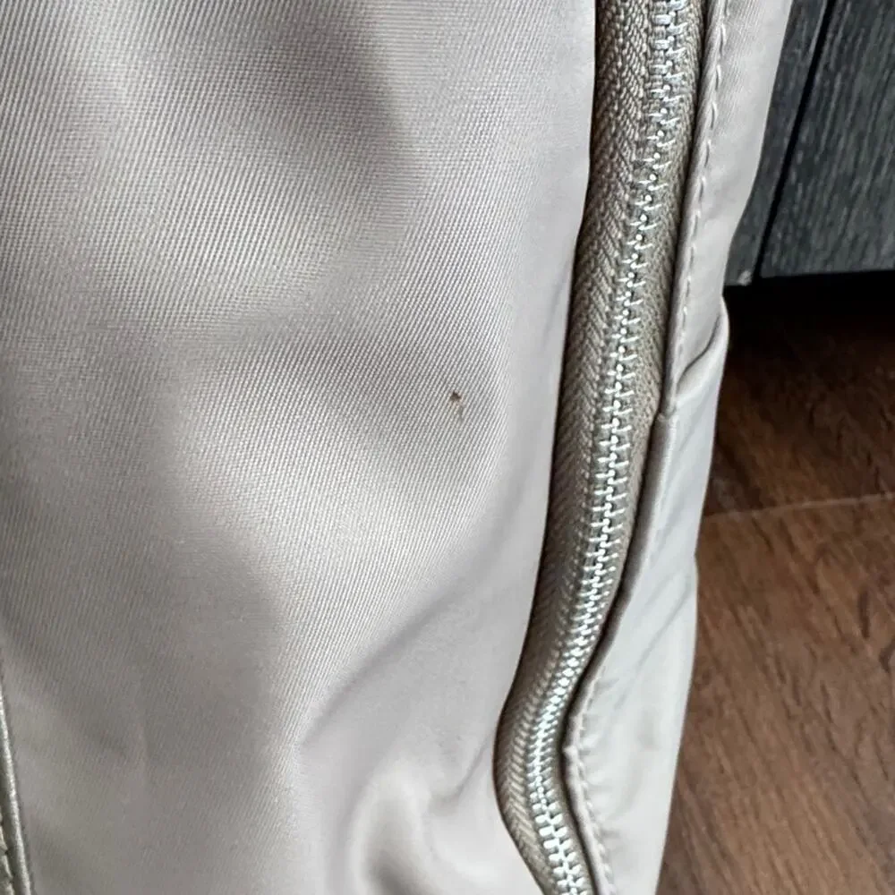 Neutral Taupe Woman’s Backpack with Metallic Accent and many zipper pockets. - Picture 11 of 13